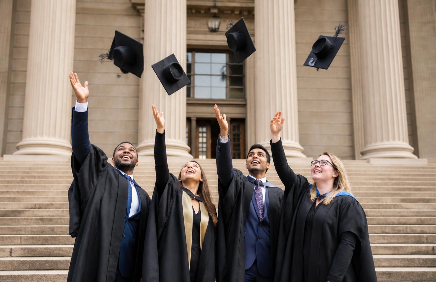 South African postgraduates celebrating on university steps